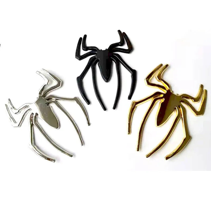 Three-dimensional metal spider bumper sticker in zinc alloy, showing gold, silver, black, and red colour options.
