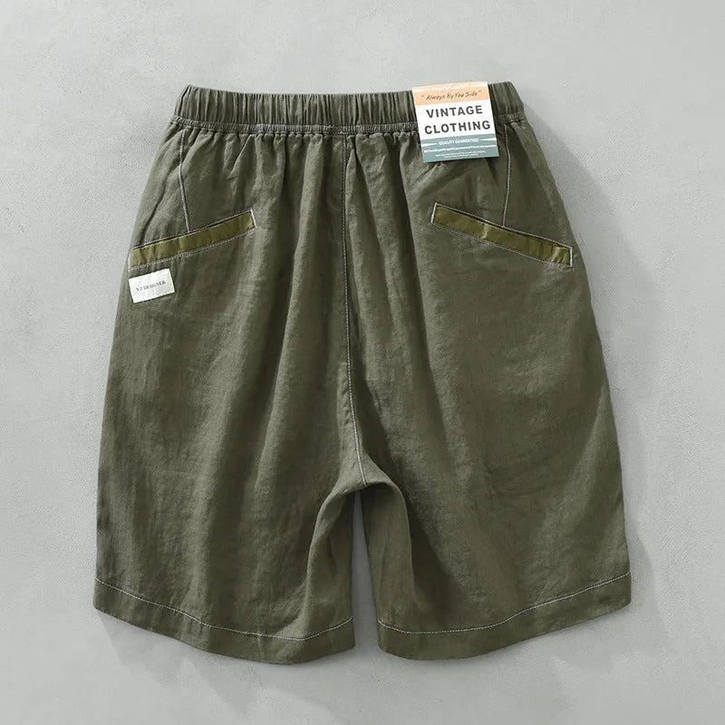 Men's straight-leg linen shorts in black or green with drooping style and drawstring mid-waist.