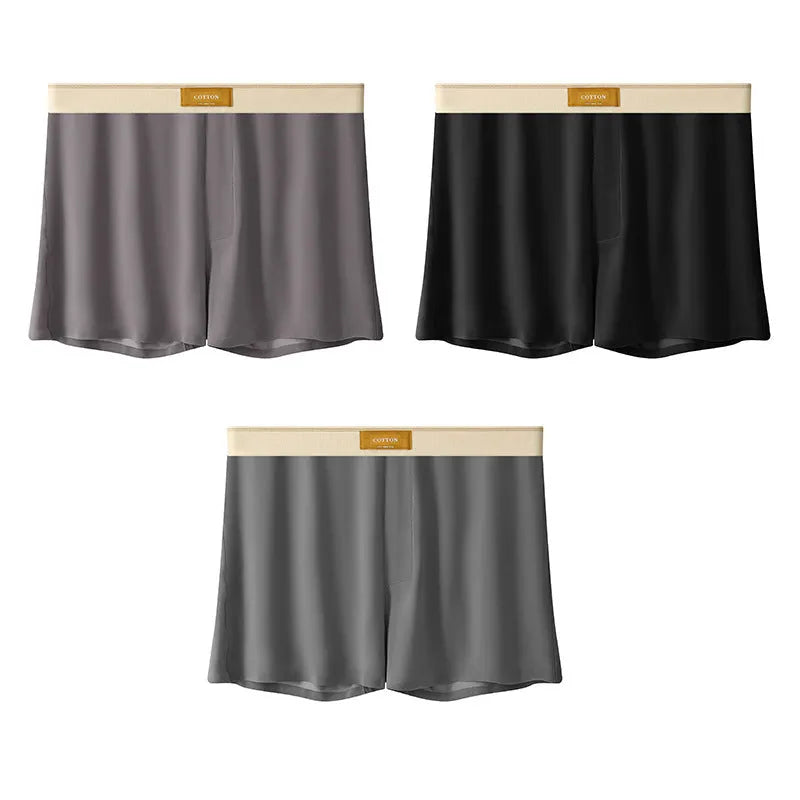 Pack of three men's loose fit ice silk boxer shorts in solid colours on a mid-waist model.