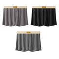 Pack of three men's loose fit ice silk boxer shorts in solid colours on a mid-waist model.