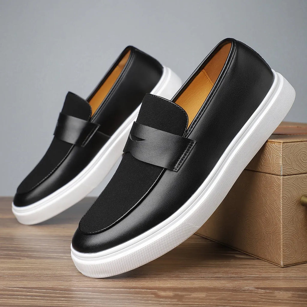 Black men's British-style slip-on casual shoes with a round toe and tassel detail on the upper.