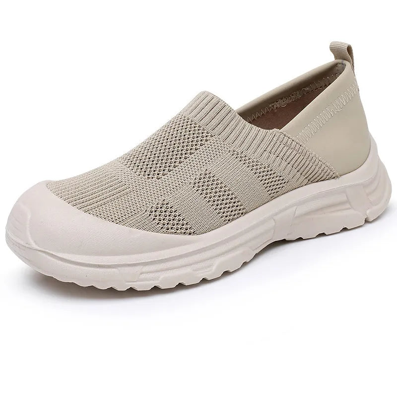 Women's black slip-on casual shoes with round toe and flat PVC sole.