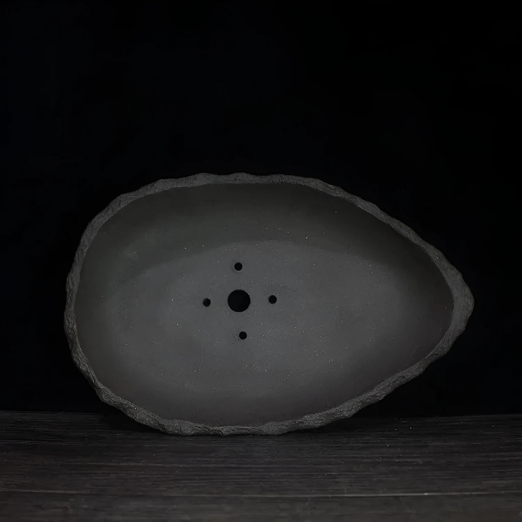 Handmade purple clay flower pot with unique shape showing three size options