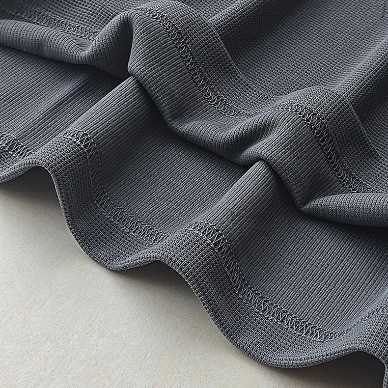 Men's dark grey heavyweight waffle-textured short-sleeved t-shirt on a hanger.