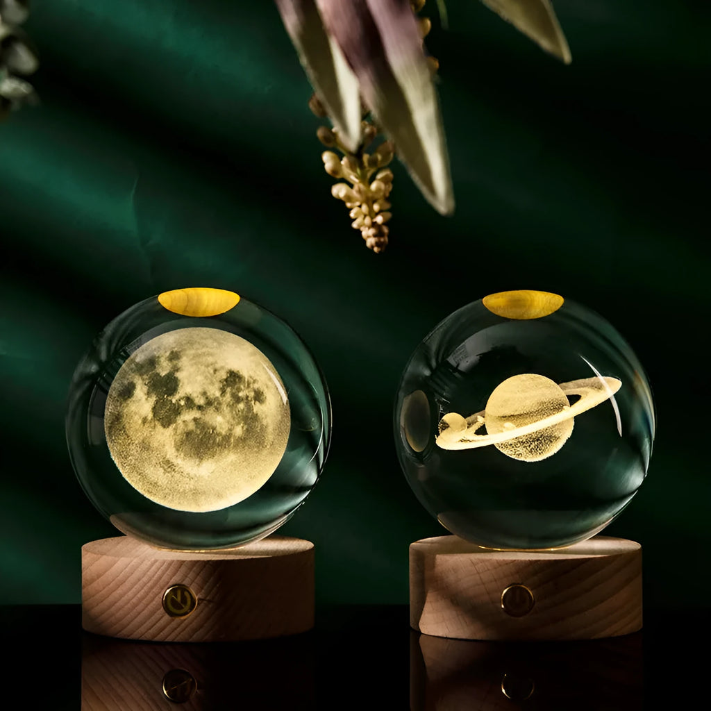 Transparent crystal ball with 3D laser inner carving of a galaxy on a beech wood base with warm light