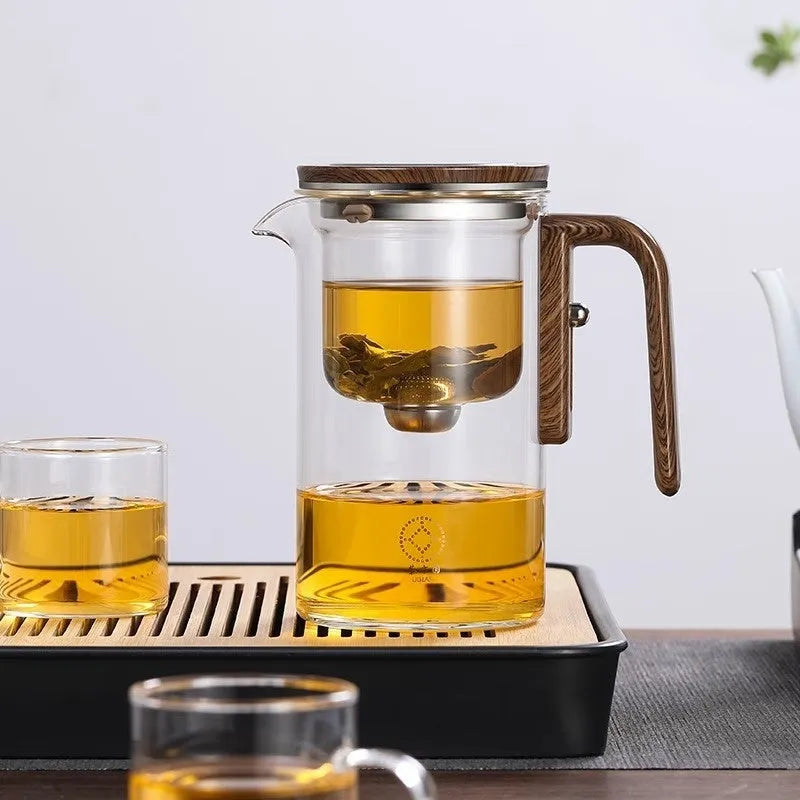 Glass teapot with magnetic tea leaf separator and wooden handle shown in new Chinese style.