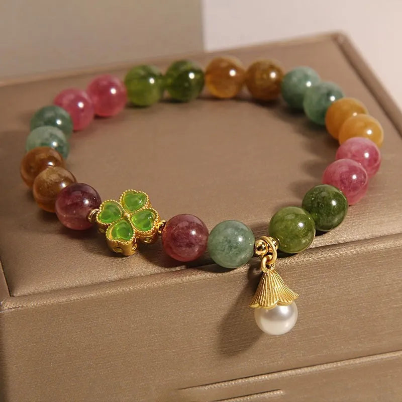 Women's colourful tourmaline bracelet with four-leaf clover charm and pearl pendant on a mixed material electroplated chain.