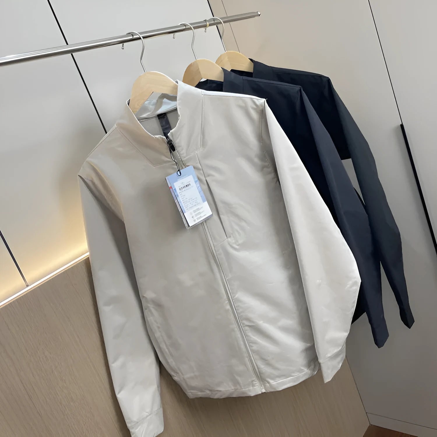 Men's stand collar casual jacket in polyester, shown in black, dark blue, and beige.