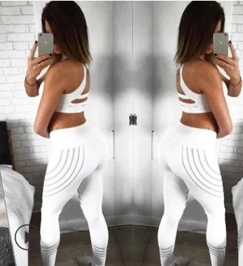 Women's black high-waisted workout leggings with night glowing print pattern on legs