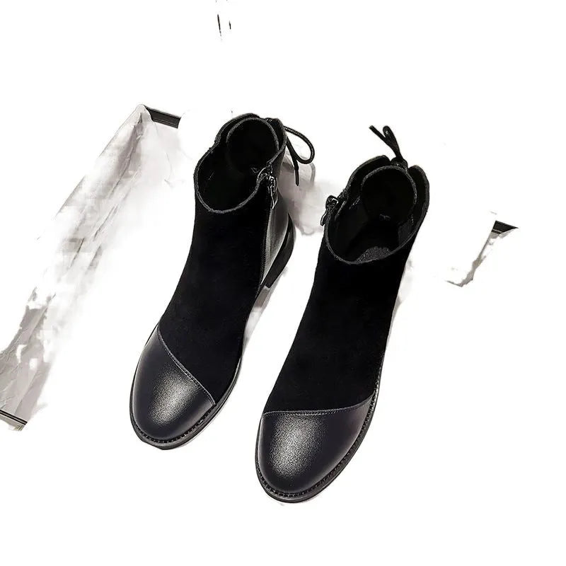 Black women's knee-high Martin boots with side zip, round toe, and block heel on a rubber sole.