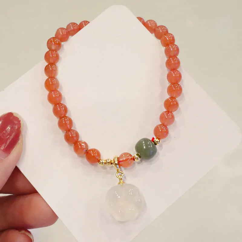 Natural red agate bracelet with 6mm beads and 8mm cat paw charm featuring gemstone inlay