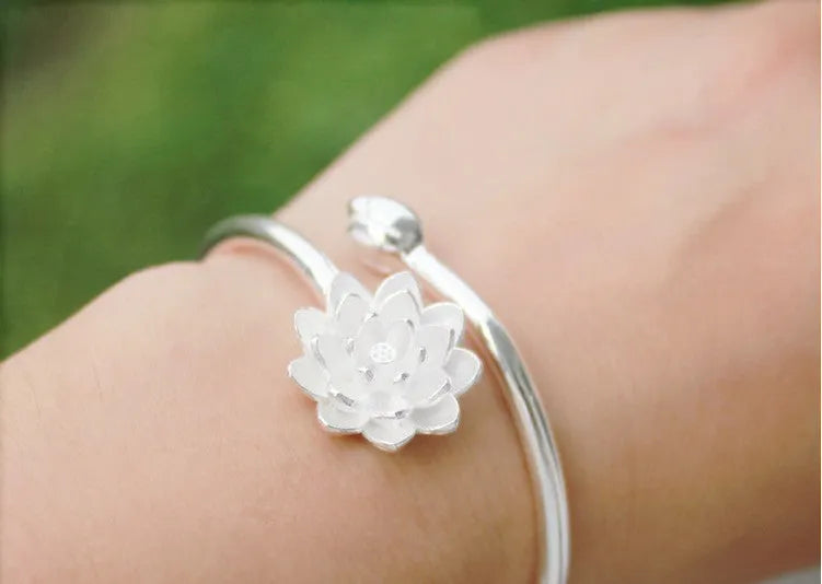 Snow Lotus silver open style bracelet on wrist showing lotus motif and electroplated finish