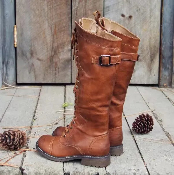 Women's black chunky heel high-leg boots with a round toe and low rubber sole.