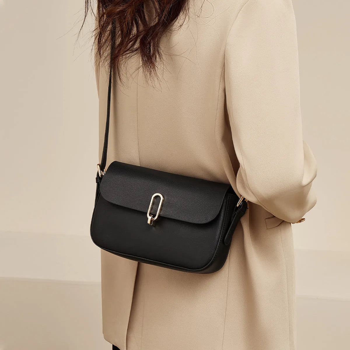 Black genuine leather square messenger bag with shoulder strap and lock detail