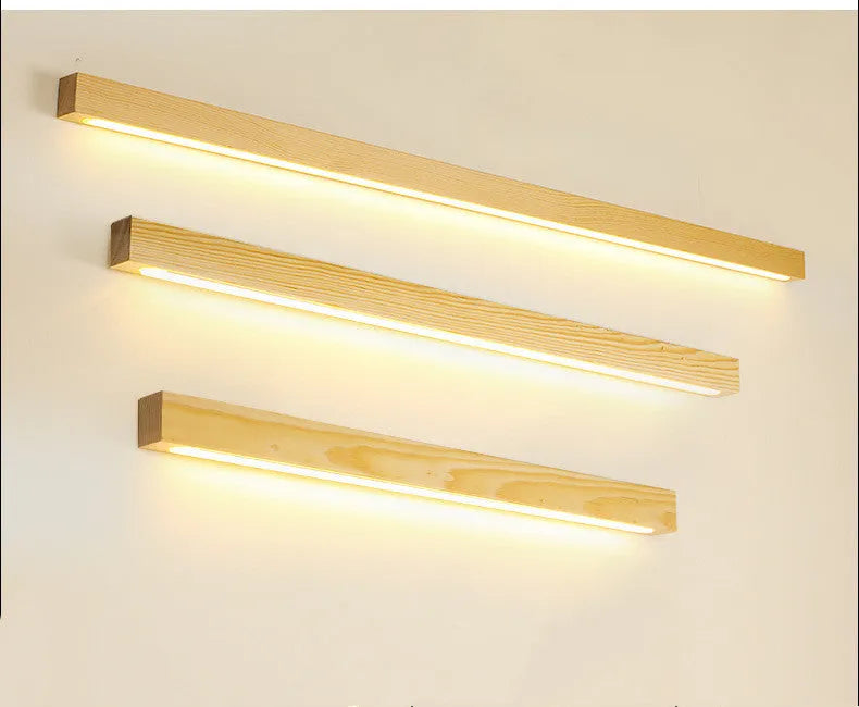 Modern Walnut wood and acrylic log strip wall lamp mounted on a wall in a living room setting.