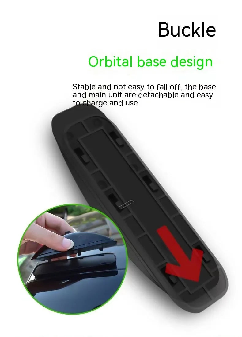 Black vehicle-mounted laser lamp with remote control and USB charging cable on a car dashboard.