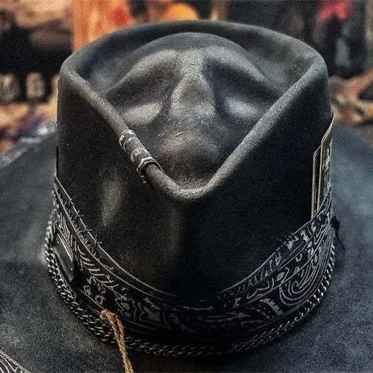 Handmade wool felt skull hat with a conical crown shape on a mannequin head.