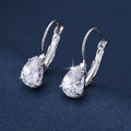 Gold and platinum drop earrings with a cubic zirconia stone set in a simple metal design.