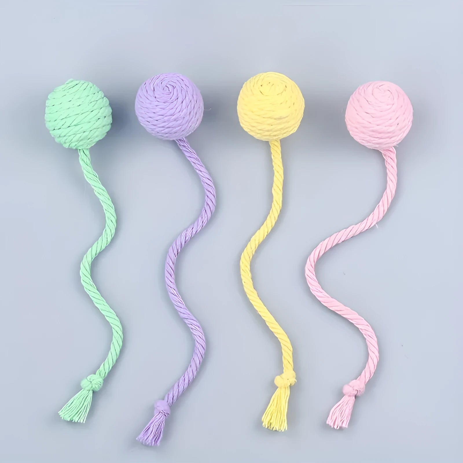 Cat toy ball with attached rope in green, pink, purple or yellow colours showing 3cm and 6cm size options