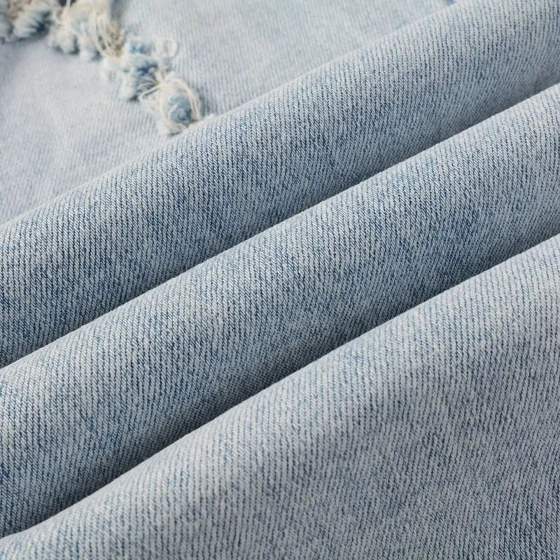 Light blue slim fit stretch men's jeans with distressed details and diamond patch pocket