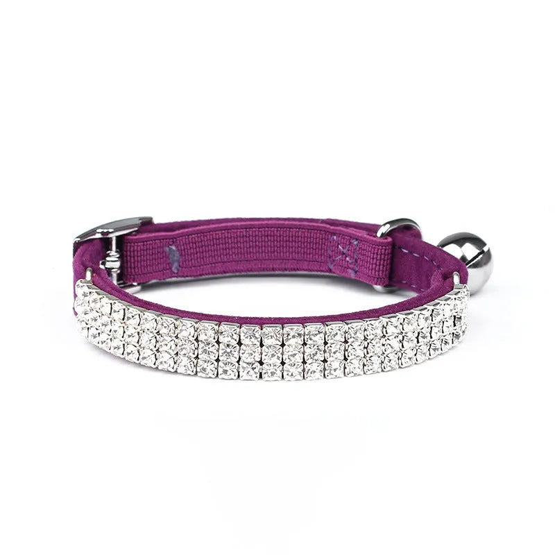 A soft velvet cat collar with a central rhinestone, shown in one of five available colours.