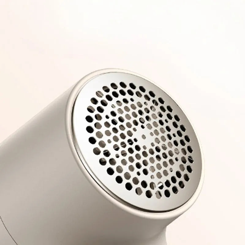 White electric lint remover with LED display showing fabric shaver dimensions