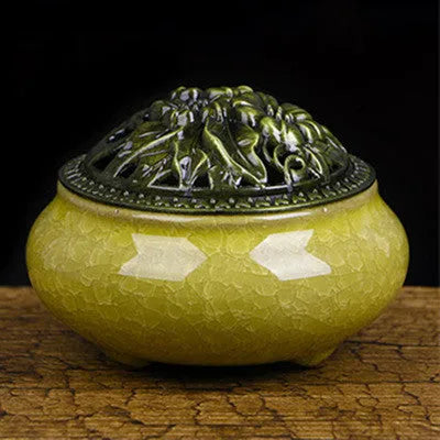 Ceramic incense burner in choice of twelve colours, shown next to incense sticks.