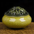 Ceramic incense burner in choice of twelve colours, shown next to incense sticks.