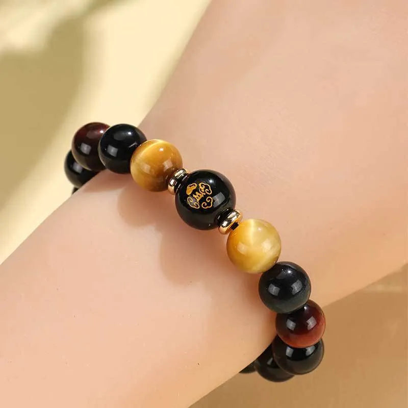 Handmade black agate bracelet with zodiac animal charms and gold tiger eye beads on wrist