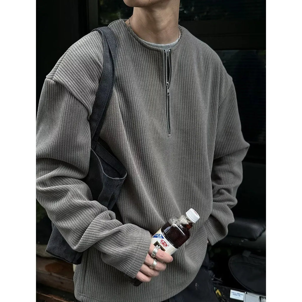 A woman's solid grey long sleeve loose fit pullover top on a hanger.