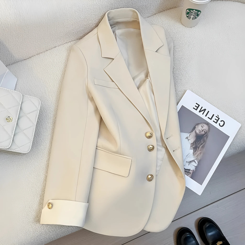 Milky white loose-fit mid-length women's coat with long sleeves and pockets on a hanger.