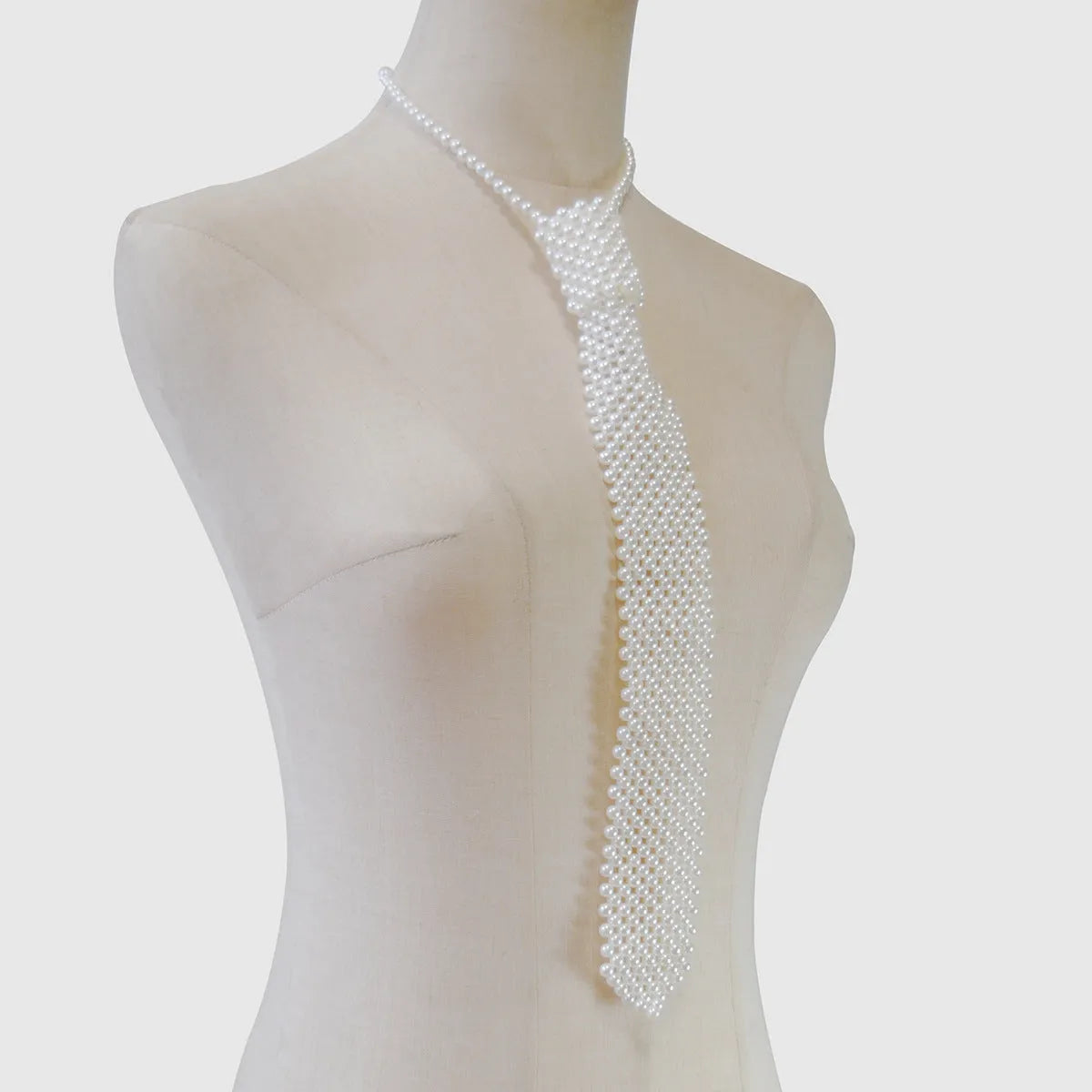 Adjustable pearl body chain with hollow-out design and alloy tie clasp in white or black colour