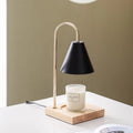 Wax melting lamp with oak wood base and white iron lampshade on a bedside table
