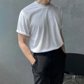 Men's slim fit black cotton t-shirt with round neck and half sleeves on a model.