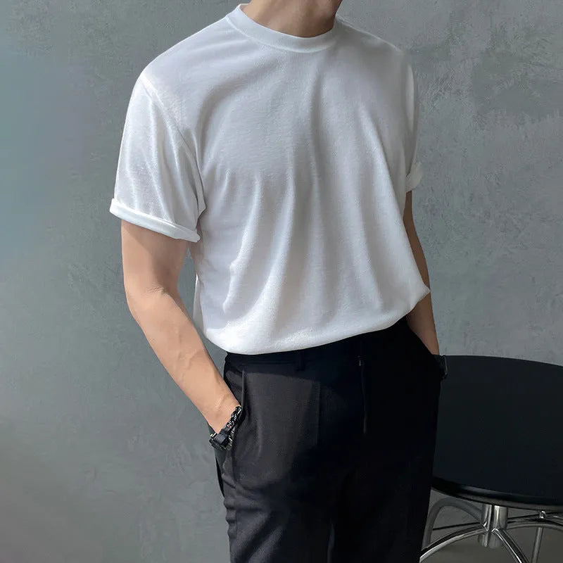 Men's slim fit black cotton t-shirt with round neck and half sleeves on a model.
