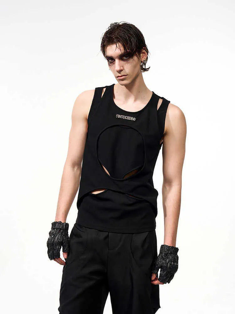 Man wearing a loose-fit black sleeveless hollow thread waistcoat vest.