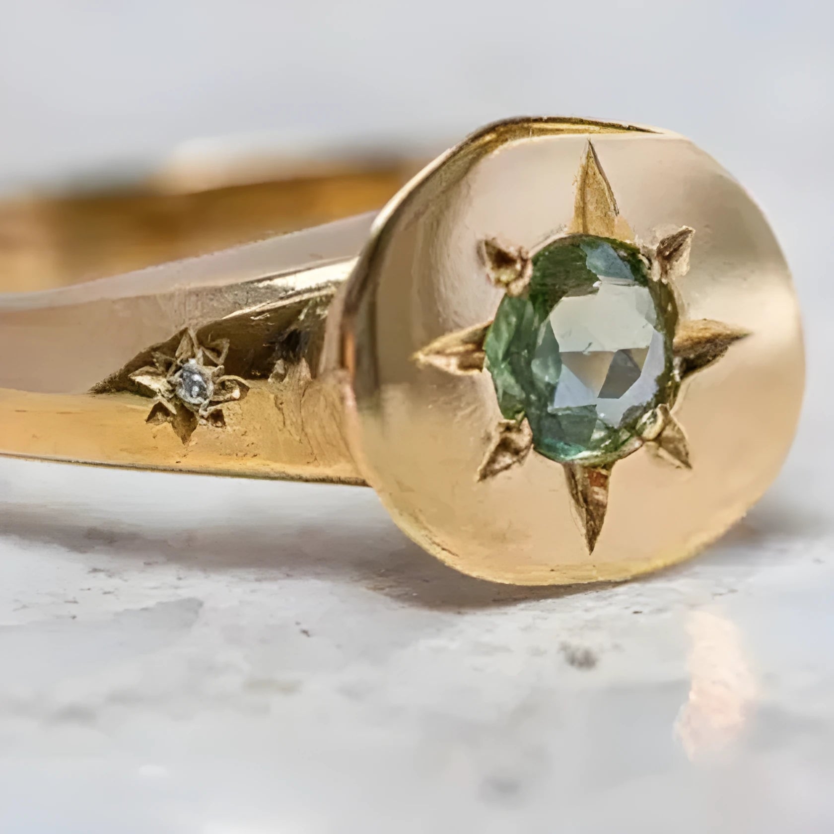 Gold-colour adjustable ring with an oval-shaped star design and central zircon stone.