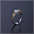 Copper crown-shaped crystal ring in a black gold tone on a neutral background.
