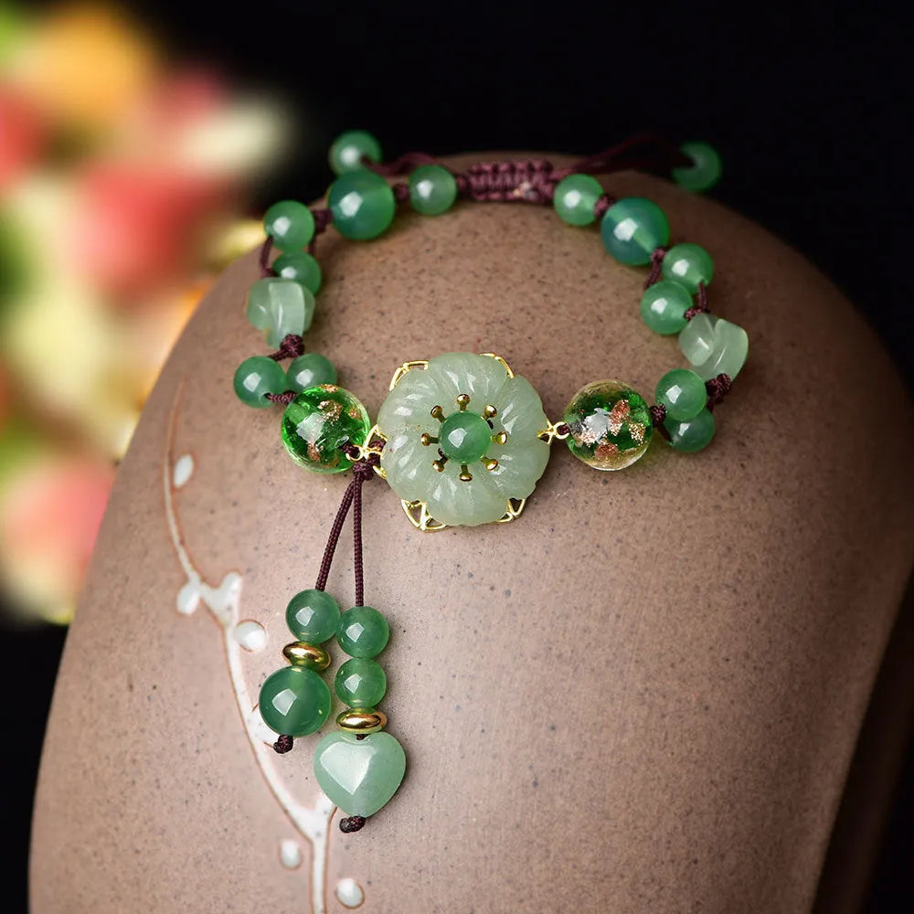 Women's hand-woven bracelet with Chinese auspicious patterns showing flower elements and mixed material texture