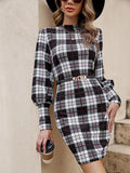 Black tight-fitting dress with voluminous lantern sleeves and decorative leather stitching.