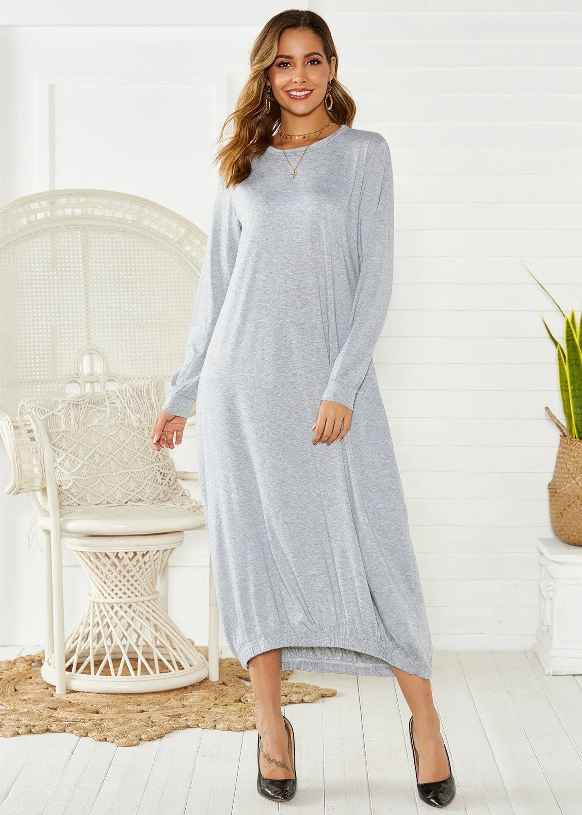 A loose black lantern dress with a lace-up crew neck, made from knitted polyester fabric.