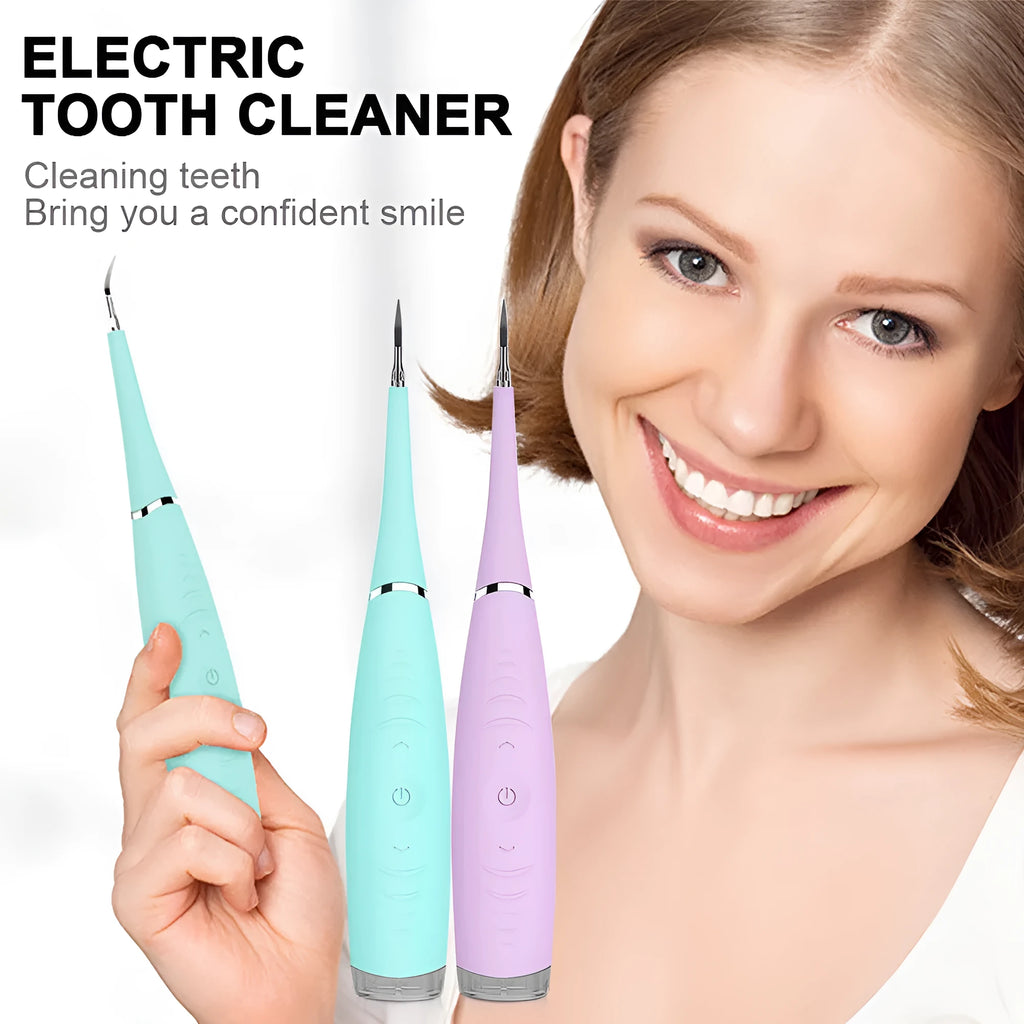 Pink and blue electric dental scaler tool with silicone handle on a bathroom counter.