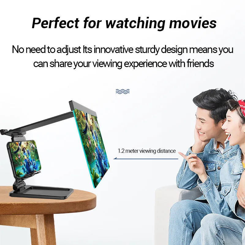 Black folding mobile phone screen magnifier with detachable holder on a desk.