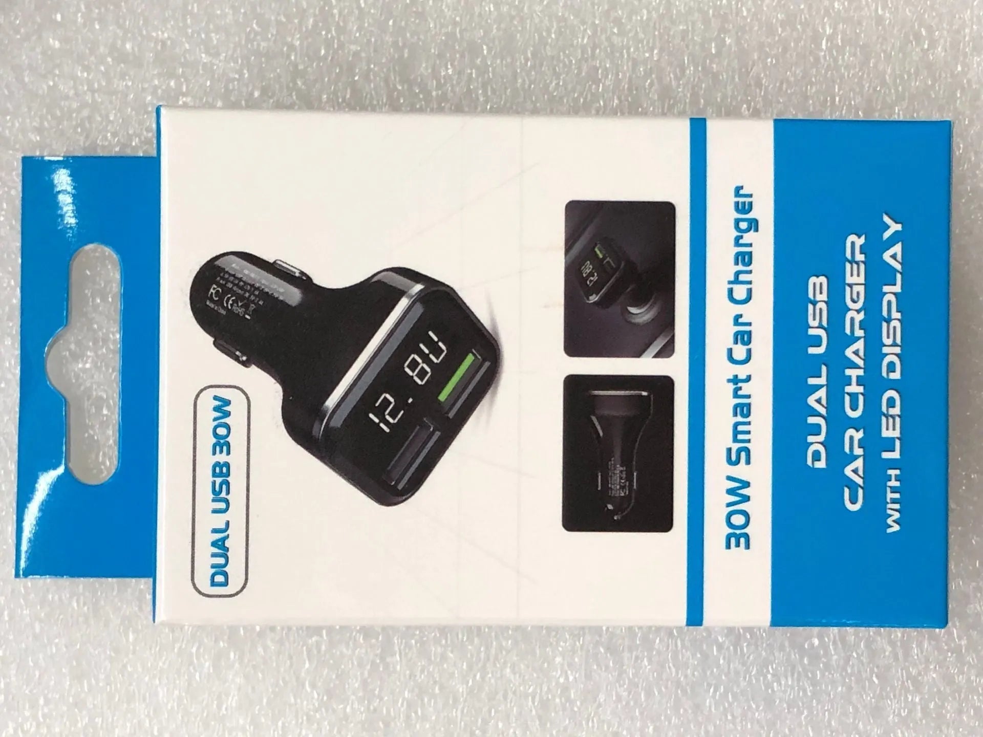 Black car charger with digital display showing voltage and current readings, dual USB ports