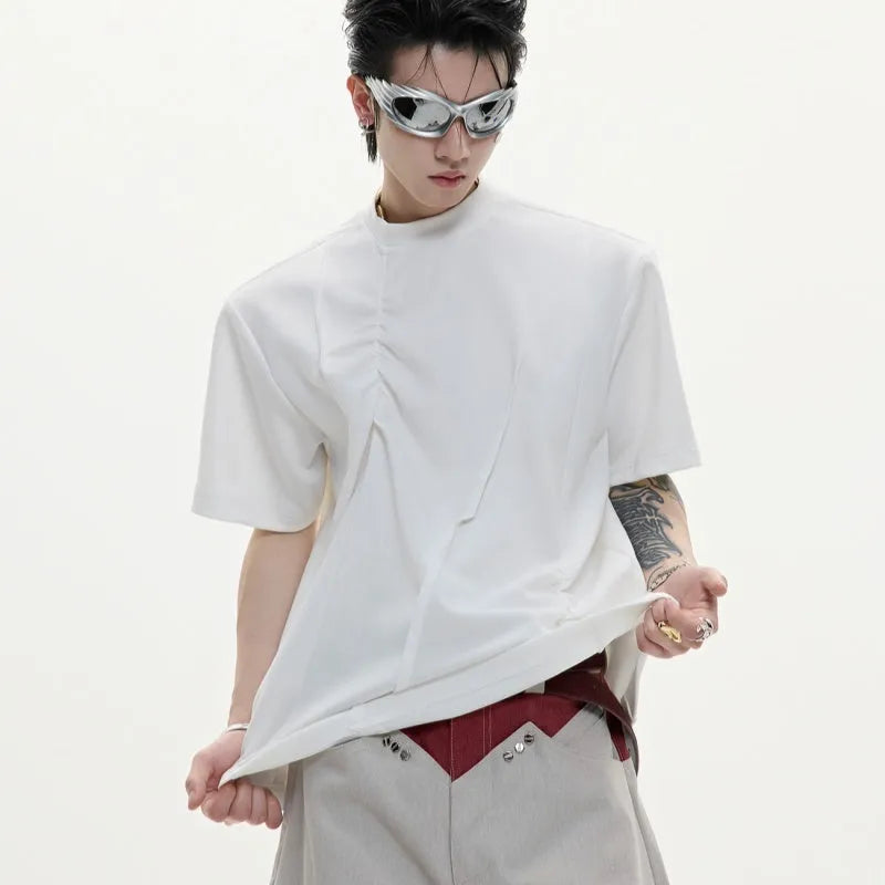 Men's black cotton T-shirt with three-dimensional pleats on the front, showing a round neck and short sleeves.