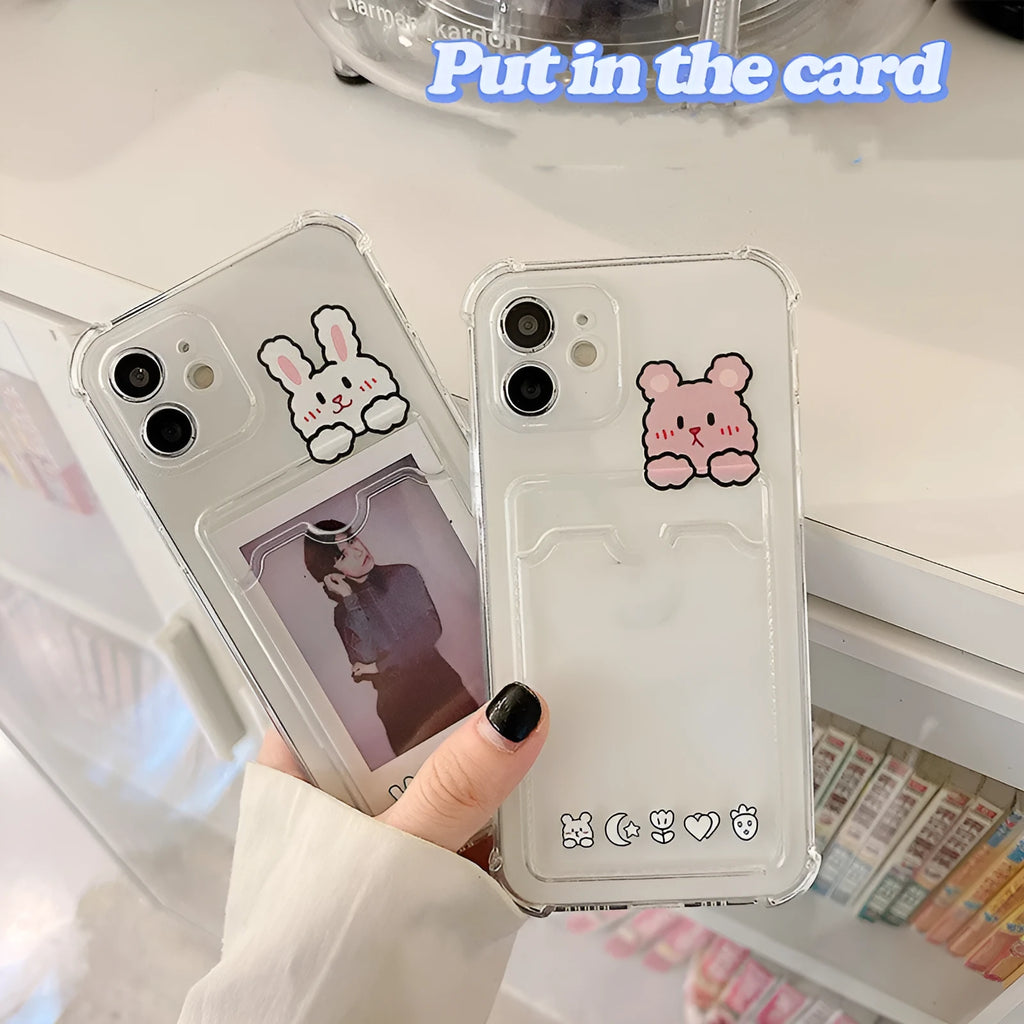 Transparent cartoon card holder phone case for Apple iPhone on a table.