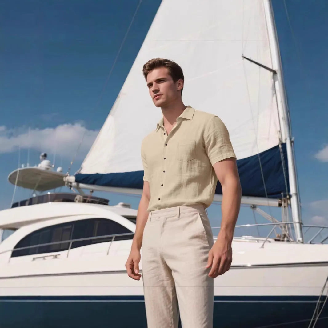 Man wearing a loose-fit light blue linen short-sleeved shirt in a casual setting.