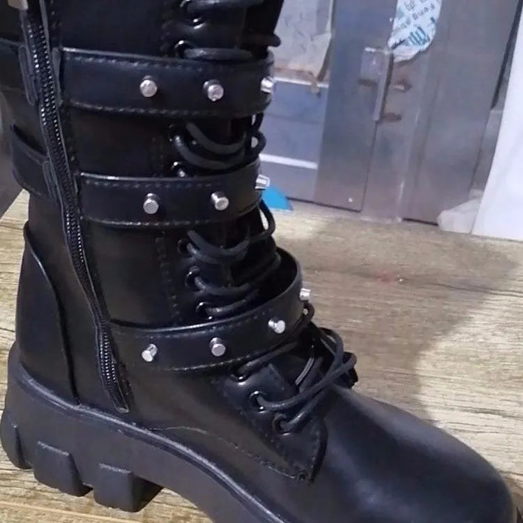 Women's black mid-calf knight boots with a large metal buckle and side zipper detail.