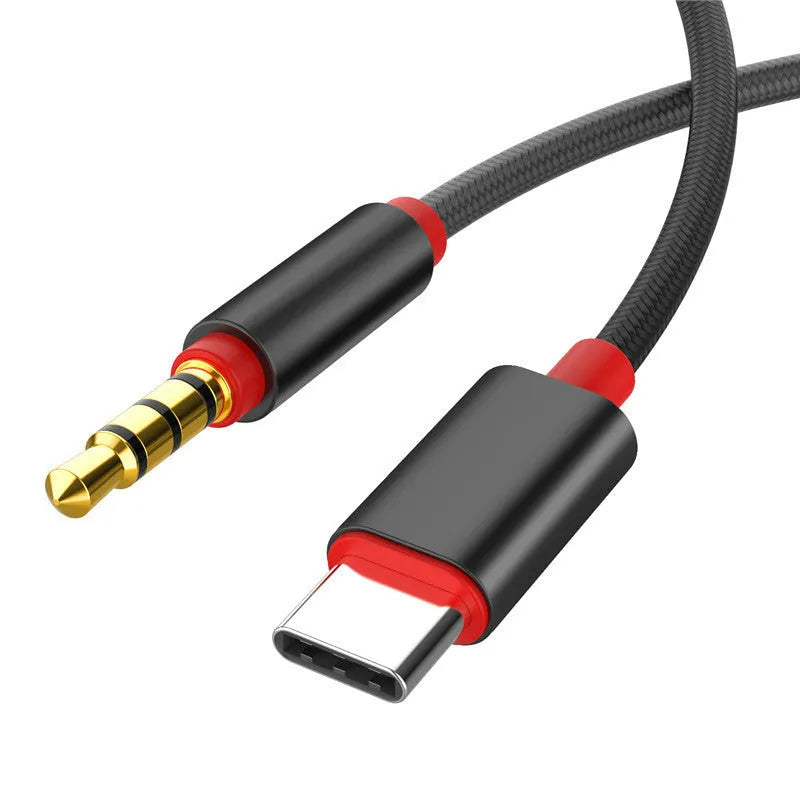 Silver nylon audio cable with 3.5mm connectors for car use on a grey background.