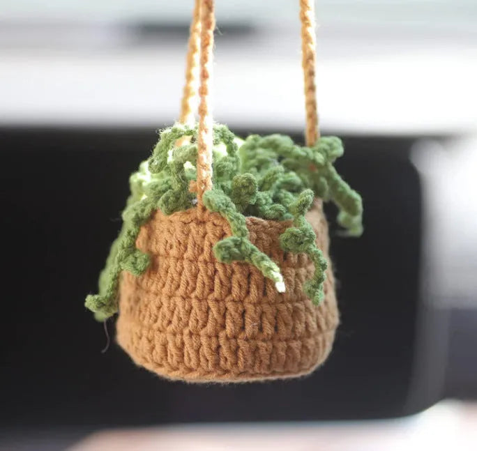 Green and white knitted wool car plant decoration with 8cm base and hanging rope.